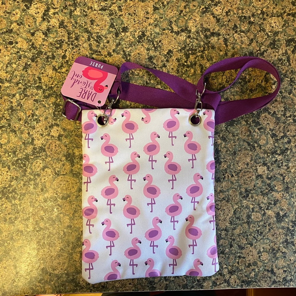 NWT- Super cute crossbody flamingo purse. Two zippers. Adjustable strap.
